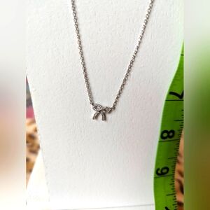 Real silver dainty bow with rhinestone details